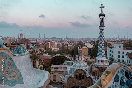 Barcelona, Spain - April 19 2022: Park Guell created by Antoni Gaudi. Beautiful colorful architecture with ceramic mosaic