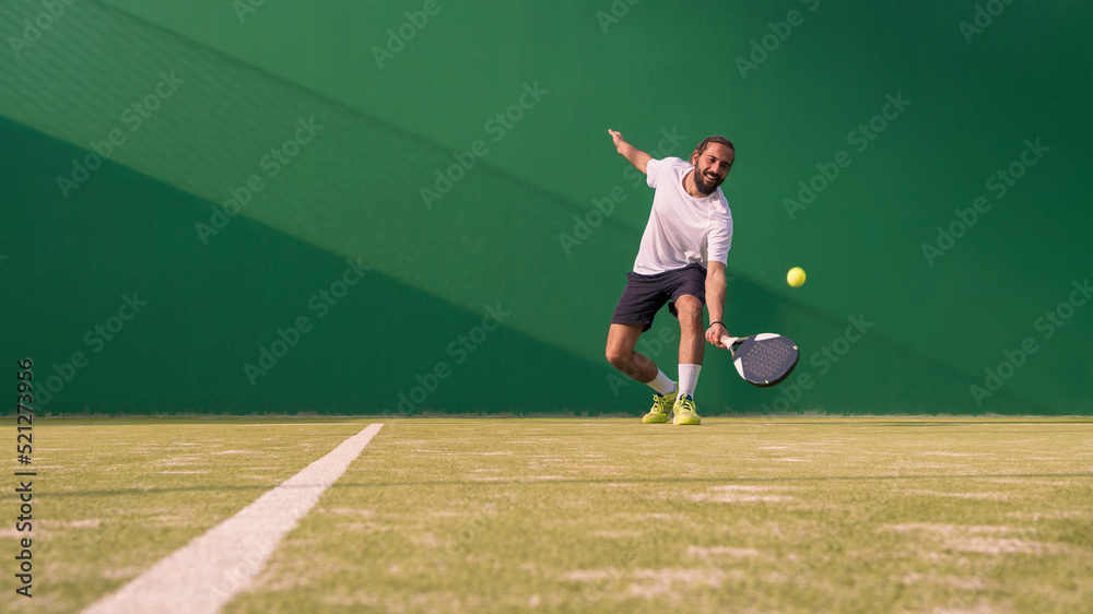 Professional monitor of padel jump to the ball with a black racket. Sport game Professional monitor of padel jump to the ball with a black racket. Sport game