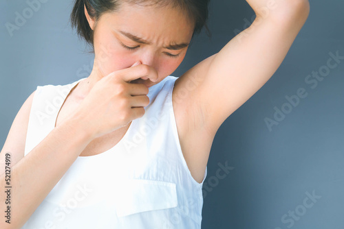 Wallpaper Mural Woman covering her nose due to body odor problem Torontodigital.ca