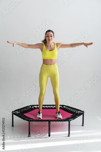 young fitness woman In sportswear jumping on sport trampoline