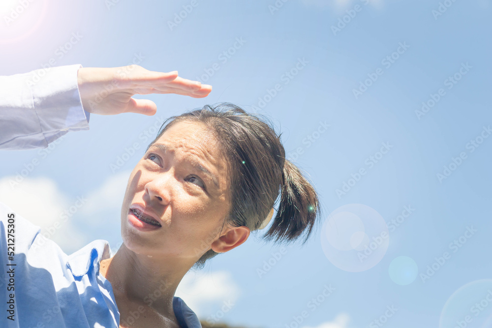 custom made wallpaper toronto digitalAsian woman shields herself from the sun on a scorching summer day.