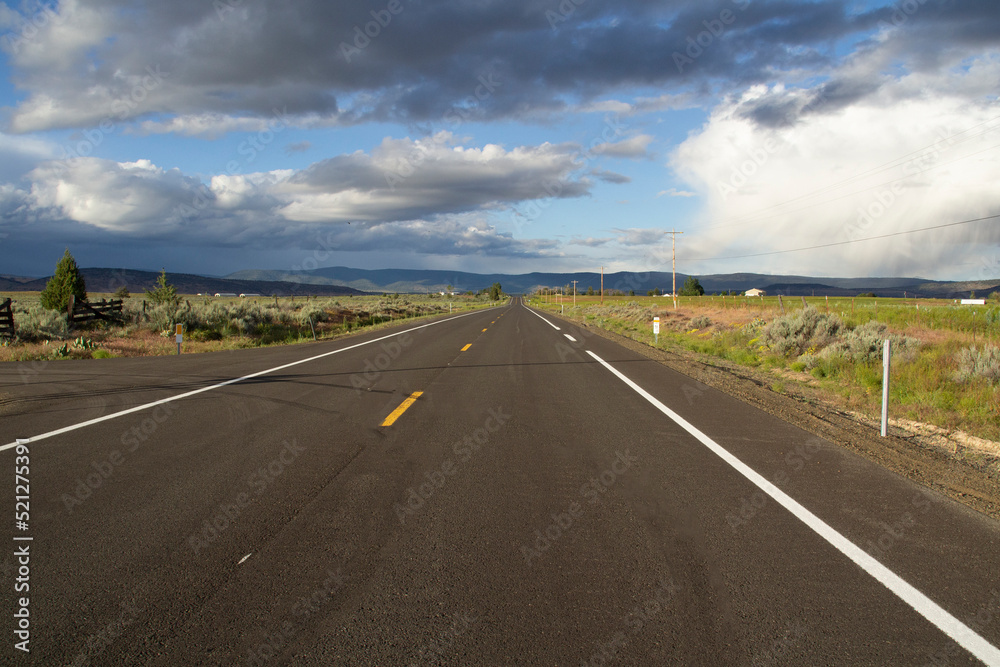 Long Straight Stretch of Paved Two Lane Road Under Cloudy Skies in Klamath County, Oregon Long Straight Stretch of Paved Two Lane Road Under Cloudy Skies in Klamath County, Oregon