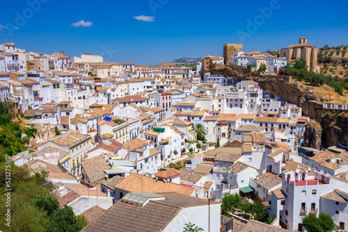 Setenil de las Bodegas. Typical andalucian village with white houses and sreets with dwellings built into rock overhangs above Rio Trejo. Andalusia. Spain © gatsi