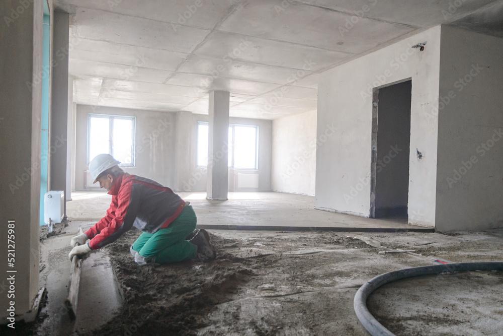 A builder in work clothes is doing his job A builder in work clothes is doing his job