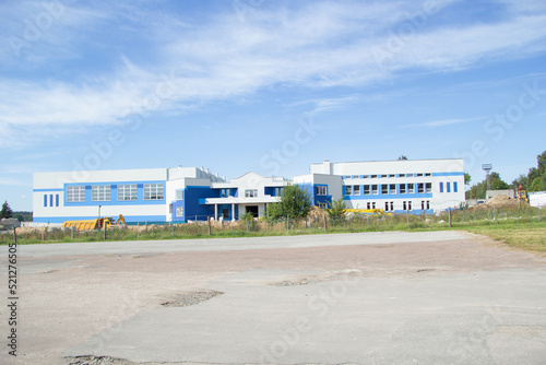 white blue building of the sports complex under construction in the summer © Natalya