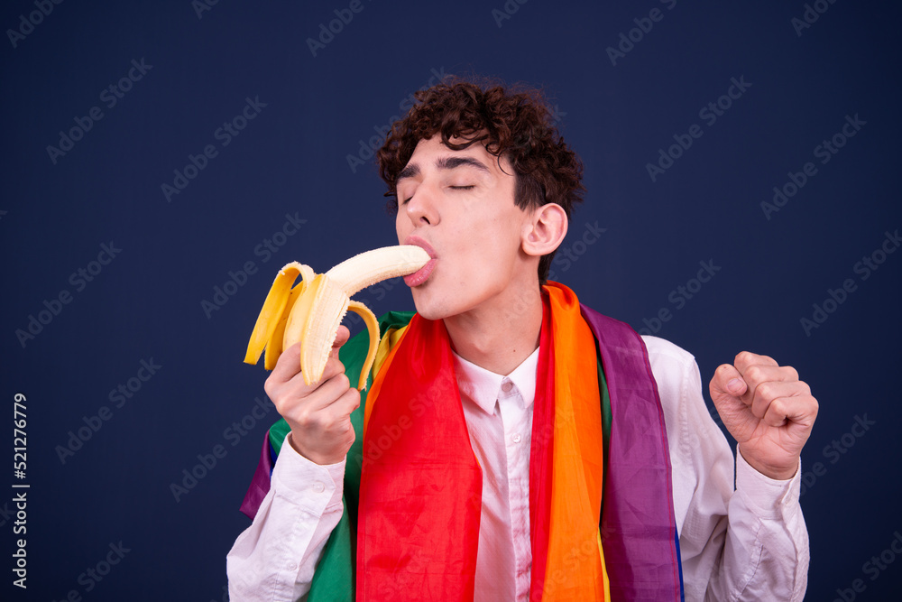 Young funny guy with a banana. Blue background. Young funny guy with a banana. Blue background.