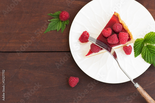 Raspberry pie (cheesecake) made from fresh raspberries with tea on a wooden background. Copy space