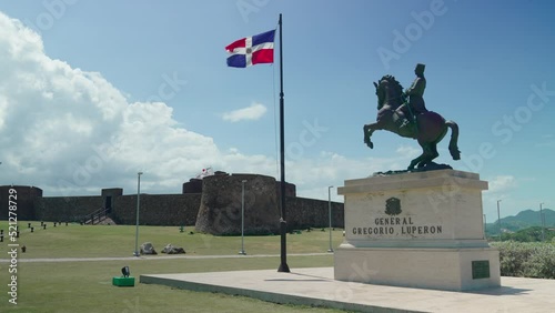 Dominican Republic flag and statue of General Gregorio Luperon in the Dominican Republic photo