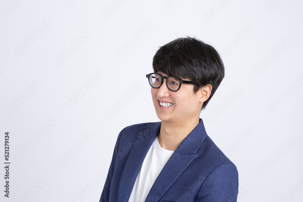 Portrait of young cheerful business man with glasses smiling and looking aside isolated on white background