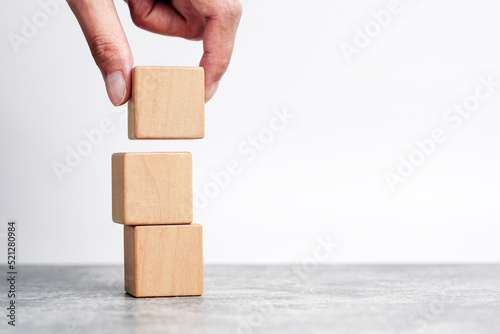 hand holding and stacking wooden block cube step of business growth success. concept of grow success.                