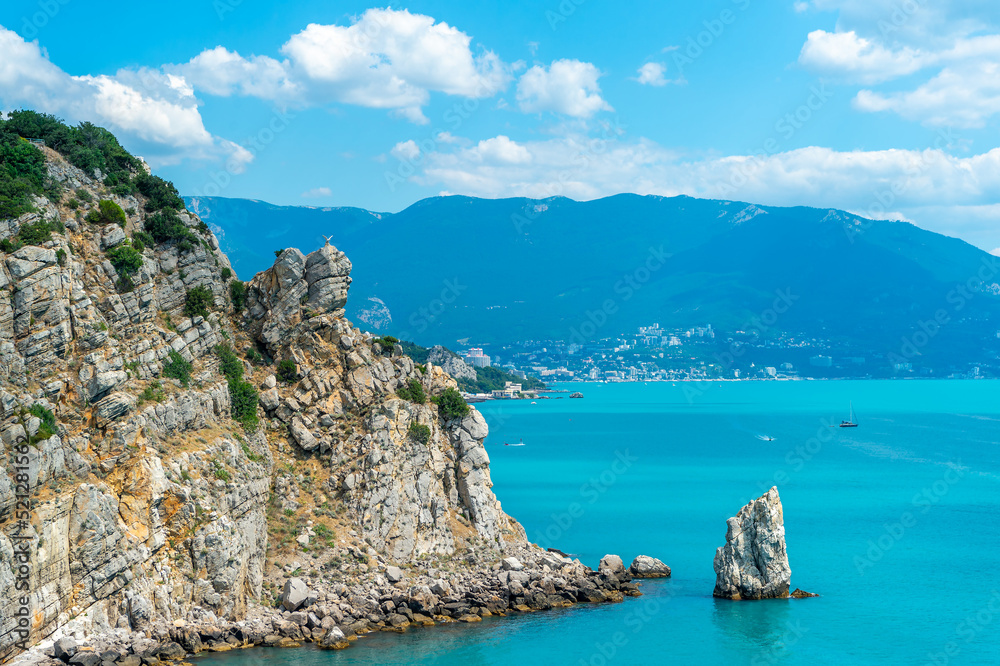 Fototapeta premium Sail Rock near the sea or ocean and blue sky with clouds, Yalta, Crimea, Swallow's Nest.