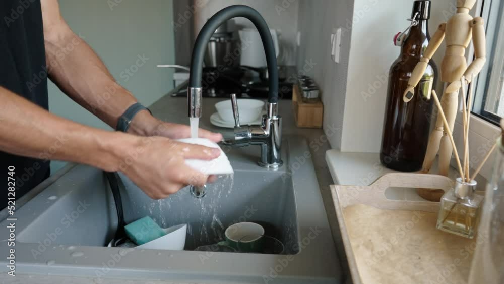 Man washing ditry dishes in kitchen sink near window, timelapse. Daily routine chores and housework Man washing ditry dishes in kitchen sink near window, timelapse. Daily routine chores and housework