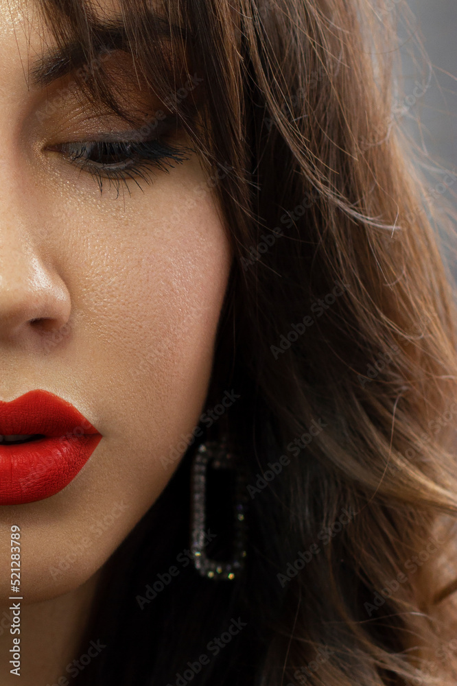 Half a beauty portrait with beautiful fashionable evening make-up, black jiggles on eyes and extremely long eyelashes. Pink lipstick on the lips. Cosmetology and spa facial skin care Half a beauty portrait with beautiful fashionable evening make-up, black jiggles on eyes and extremely long eyelashes. Pink lipstick on the lips. Cosmetology and spa facial skin care