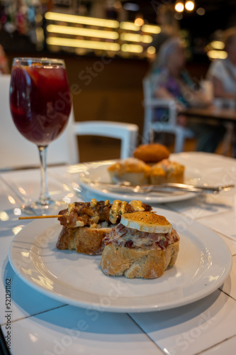 Typical snack of Basque Country and Navarre, pinchos or pinxtos, small piece of bread with different toppings, served in bar, Bilbao, Spain