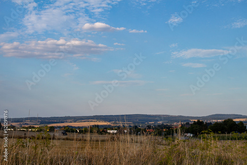 Panorama of a small German village Calden against a blue sky with clouds photo