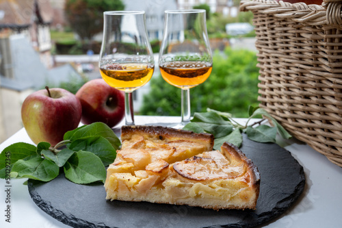 Tasting of baked apple cake and strong alcoholic drink calvados made from apples in Normandy, Calvados region, France