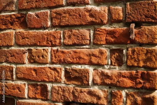 Fragment of a ceramic brick wall with white masonry mortar, white masonry seams, close-up photo