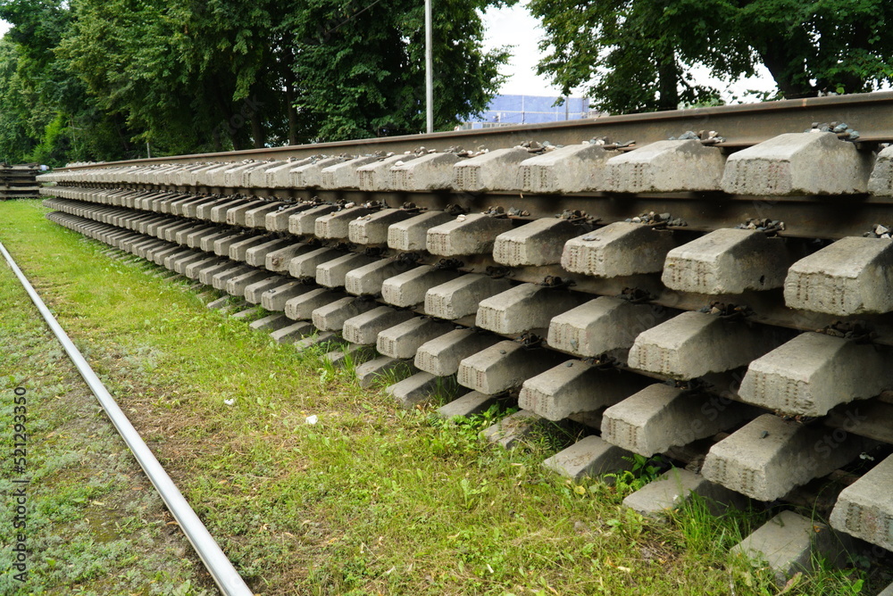 Obraz premium Old rails and sleepers. The rails and sleepers are stacked on each other. Renovation of the railway.