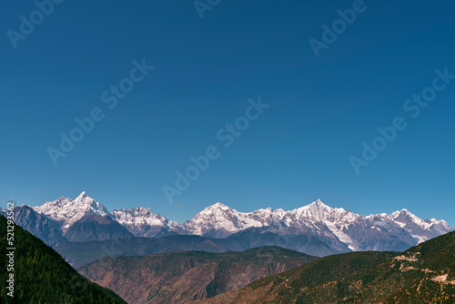 rolling mountains of meili range under blue sky
