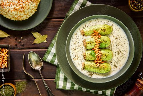 Arabic Cuisine; A delicious Lebanese stuffed zucchini in tangy garlic yogurt sauce. Served with cooked rice with vermicelli and topped with crispy pine nuts. photo