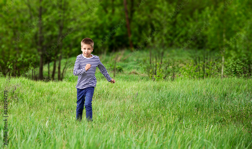 Boy running on the grass outdoors Boy running on the grass outdoors