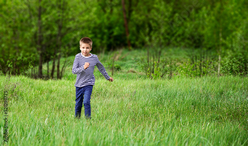 Boy running on the grass outdoors