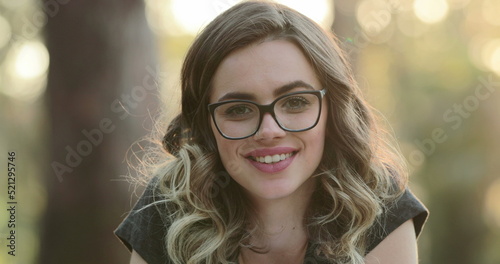 Beautiful hispanic student girl smiling to camera. Portrait of happy latina young woman wearing glasses looking to viewer