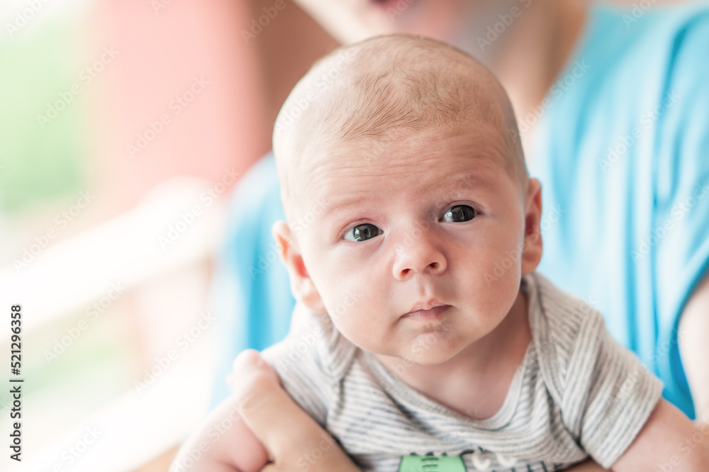 Close-up detail portrait of cute little peaceful newborn baby boy child face with beautiful open eyes. Love and family emotion Close-up detail portrait of cute little peaceful newborn baby boy child face with beautiful open eyes. Love and family emotion
