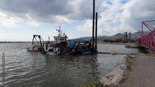 Footage of ships cleaning the sea in Bayrakli, Izmir in cloudy sky background photo