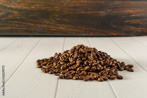 pile of coffee beans over white background © Felippe Lopes