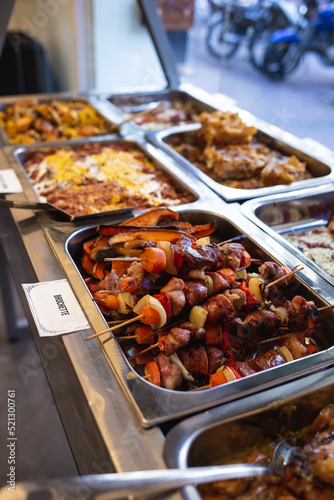 tray with different dishes of food in a buffet