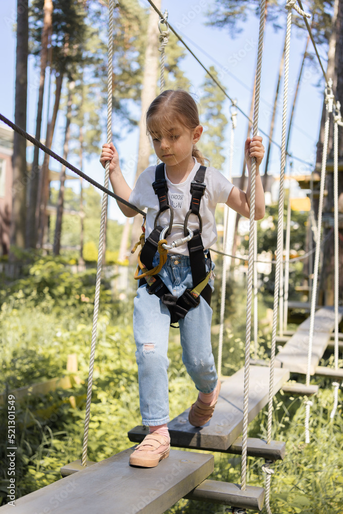 Rope park. Child girl having fun at adventure park. Rope park. Child girl having fun at adventure park.