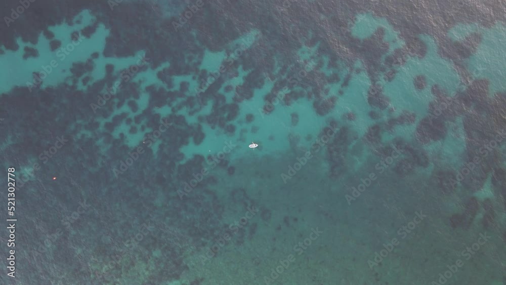 Aerial view of a small boat along the coast in Pomonte, Elba Island, Tuscany, Italy. Aerial view of a small boat along the coast in Pomonte, Elba Island, Tuscany, Italy.