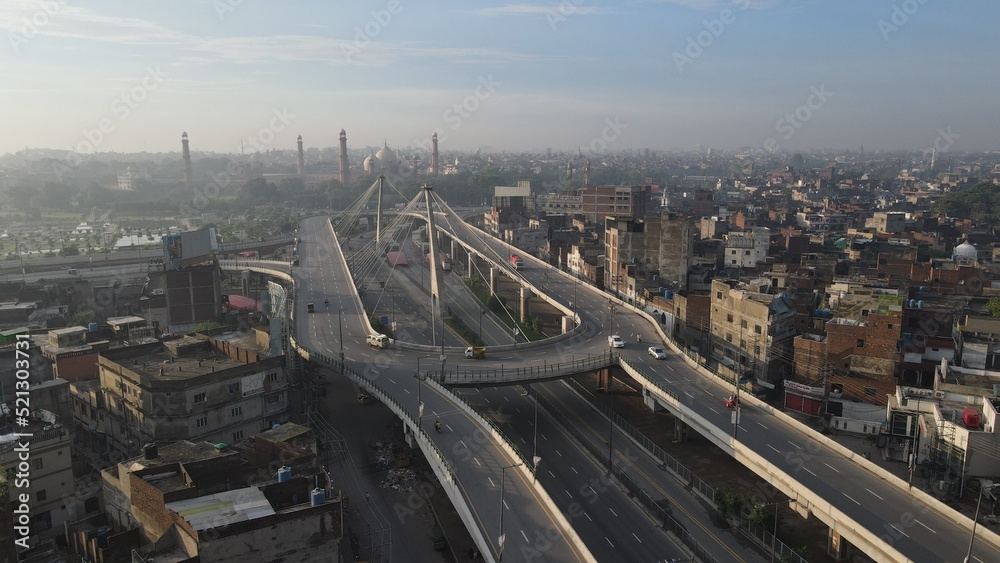 An aerial image of the Aazadi Chowk Interchange, located near the old city which includes historical landmarks of Lahore Fort and the famous Badshahi Mosque.