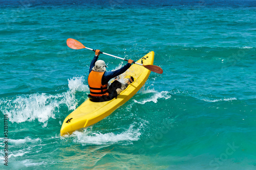 Kayaker passes the oncoming wave