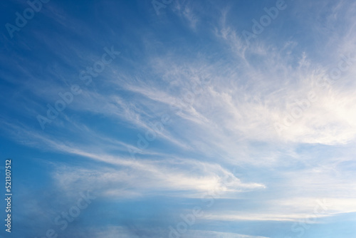 Sky, beautiful clear blue sky with fluffy soft white clouds as a natural background or surface with copy space. Natural background concept photo with clouds in a sunny day