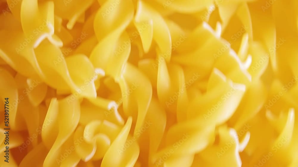 Uncooked Fusilli Pasta - Top View. Fat and Unhealthy Food. Dry Spiral Macaroni, Moving Background. Italian Culture and Cuisine. Raw Golden Pasta Pattern. Downward Movement Uncooked Fusilli Pasta - Top View. Fat and Unhealthy Food. Dry Spiral Macaroni, Moving Background. Italian Culture and Cuisine. Raw Golden Pasta Pattern. Downward Movement