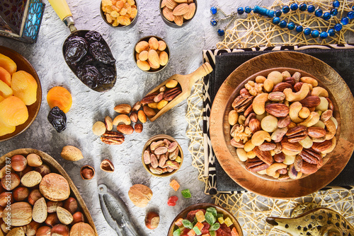 Ramadan celebration. Mix of dried fruits, dates and crispy nuts. Top view with close up. Ramadan background with close up.