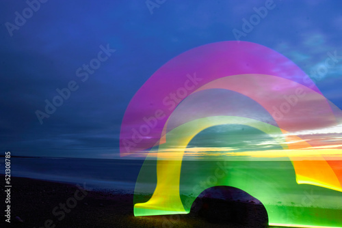 Auchenmalg Beach Luce Bay Southwest Scotland at sunset in Winter. Rainbow light trails long exposure photo