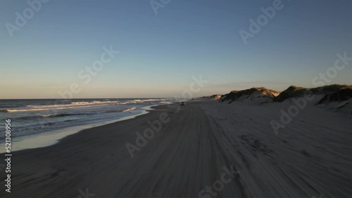 Aerial view of sea waves crashing into the sandy beach of Outer Banks island North Carolina photo