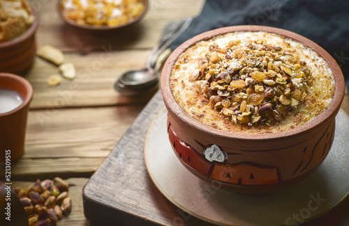 Arabic Cuisine; Traditional Egyptian dessert "Om Ali" or "Umm Ali" of soaked bread, milk and load of roasted nuts and raisins. 