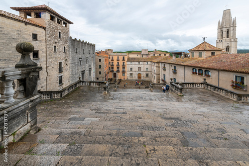 View from the top of the steps at the Girona Cathedral of Saint Mary looking down over the Jewish Quarter and medieval village streets and alleys of Girona, Spain. photo