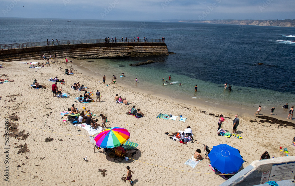 Children's Beach in San Diego, California on the La Jolla Peninsula with people enjoying the Day in the Calm Water Children's Beach in San Diego, California on the La Jolla Peninsula with people enjoying the Day in the Calm Water