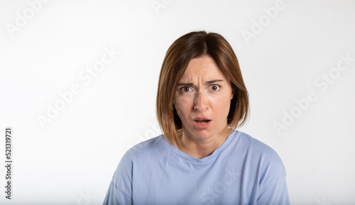 Close-up portrait of young shocked woman isolated on white background