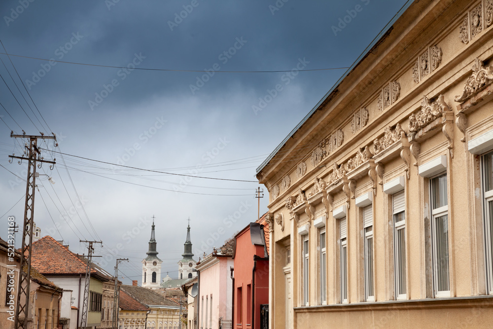 Panorama of the city of Sremski Karlovci, in Vojvodina, Serbia, with a typical vintage street with austro hungarian buildings and Saint Nicholas Church, or Crkva Svetog Nikole in background......