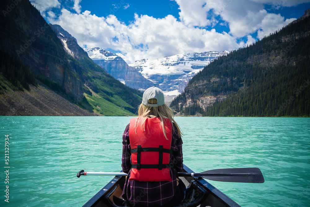 Blonde woman on a canoe in Lake Louise