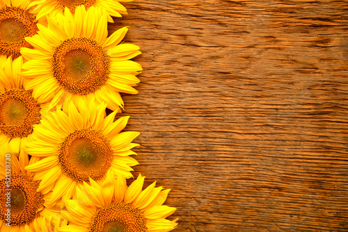 Fototapeta Naklejka Na Ścianę i Meble -  Sunflower flowers on a wooden background. Top view