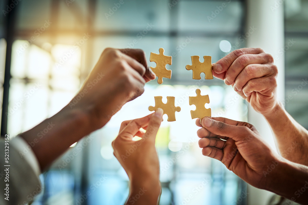 Group of business people holding puzzle pieces. Professionals connect and collaborate together inside office building. Closeup of hands, and team working together on a new strategy for success. - obrazy, fototapety, plakaty 