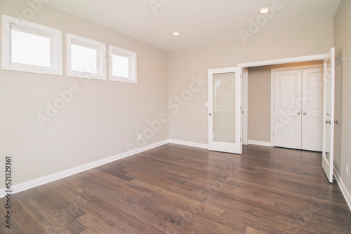 empty room with hardwood floors and a door. 