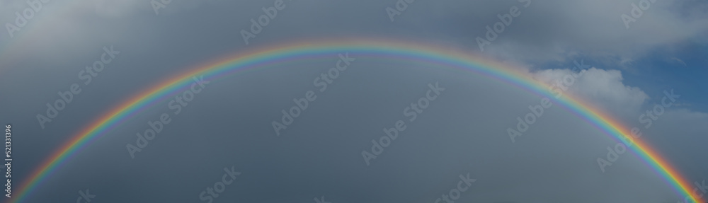 Rainbow against the disturbing sky after the rain Rainbow against the disturbing sky after the rain